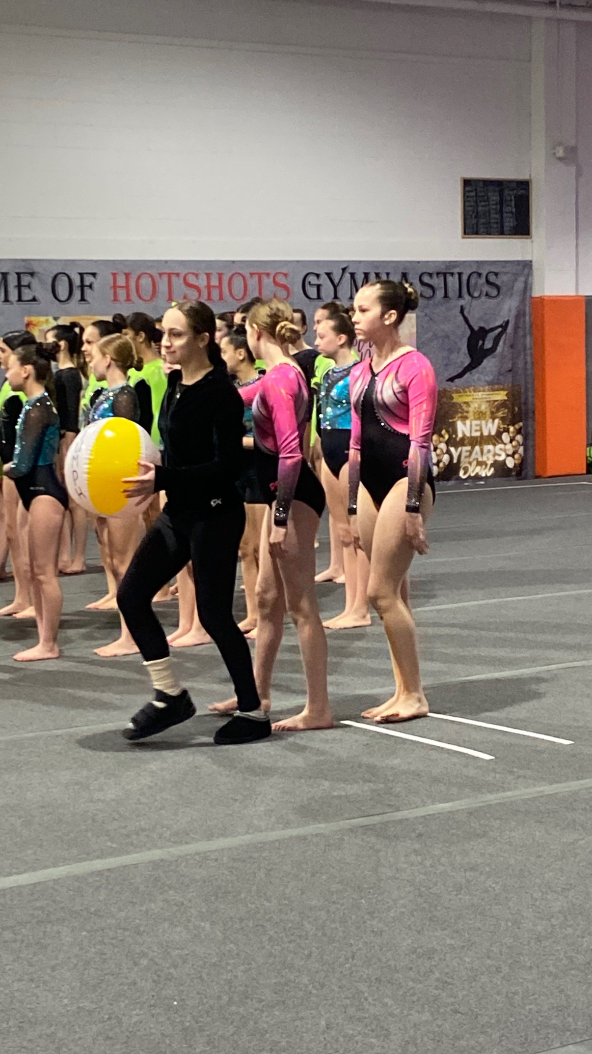 Gymnasts on awards stage with illuminated number stands