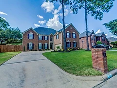 Front exterior of the red-brick Hearthstone Houses residence on Capri Circle