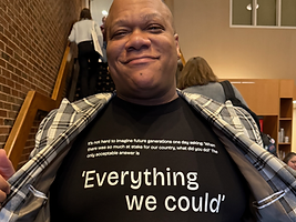 Roderick Smith wearing a t-shirt reading 'Everything we could' at a RootsCamp event.
