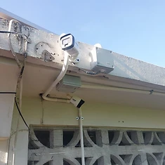 Bullet camera with junction box mounted under eaves