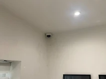 Dome camera mounted in an internal wall and ceiling corner