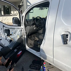 Mobile locksmith van with door panel removed for on-site commercial lockout repair by 3 Locksmiths