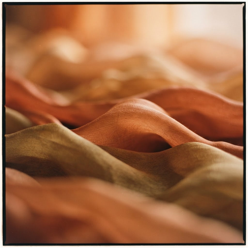 Layered silk fabric folds in warm light