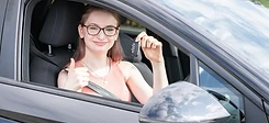 Learner holding car keys with a thumbs up after passing