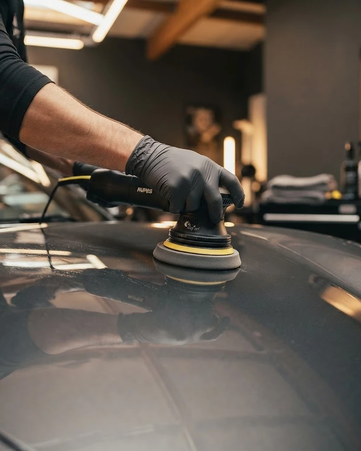 Professional polishing a vehicle to a mirror finish