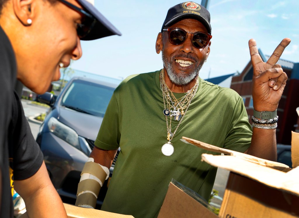 A retired veteran picks up food at an Island Harvest distribution