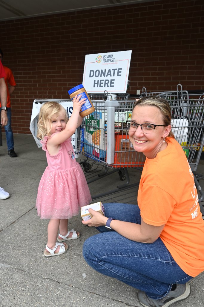 A young donor plays her part at an Island Harvest food drive