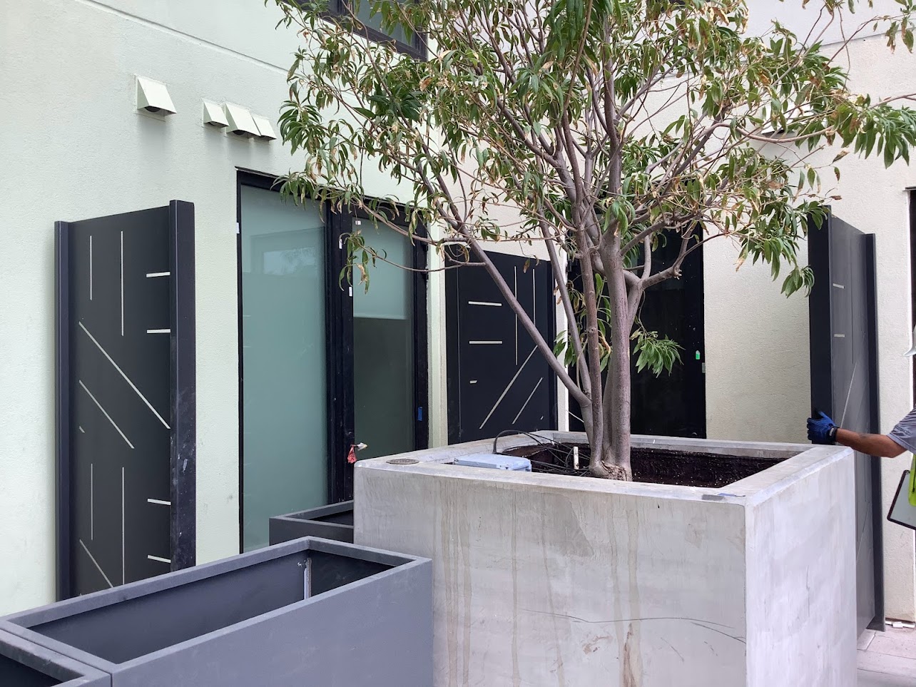 Close-up of the laser-cut steel privacy screen pattern at Moon Tower