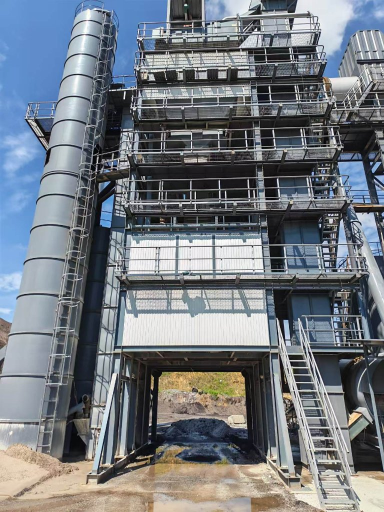 IREGE asphalt mixing plant — multi-story mixing tower with drive-through passage