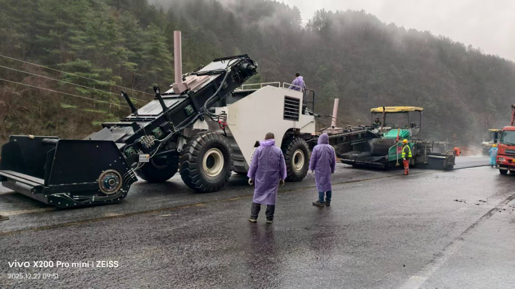 HDTV2500 feeding asphalt paver in mountainous terrain