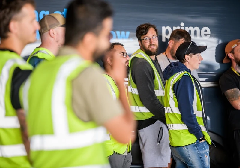 Forge Logistics drivers briefing beside vehicles at the depot