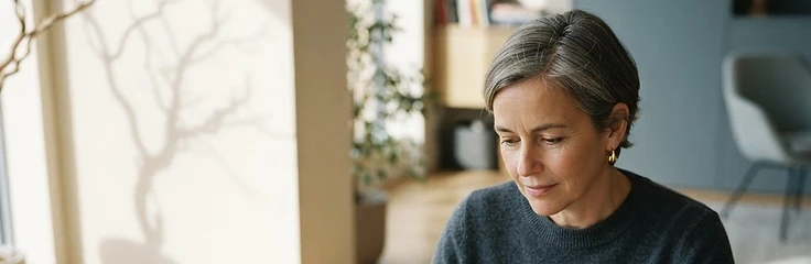 A people team leader thoughtfully comparing options at a sunlit table