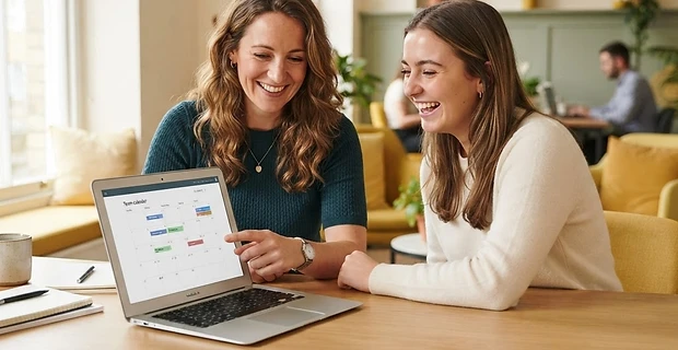 Manager and colleague planning together at a laptop