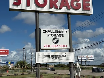 Challenger Storage street sign with the shuttle logo and phone number (281) 332-5913 on FM 528 in Webster, TX