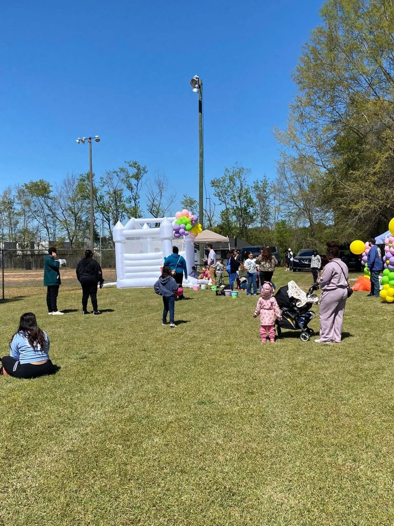 Outdoor community event with bounce house