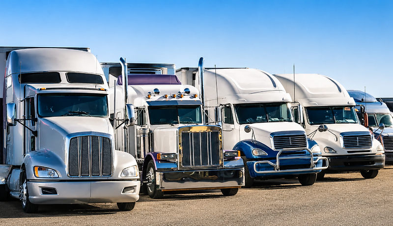 Row of heavy-duty semi trucks parked at the Truck World service facility in Greer, South Carolina