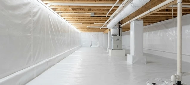 Clean, sealed crawlspace with vapor barrier installation