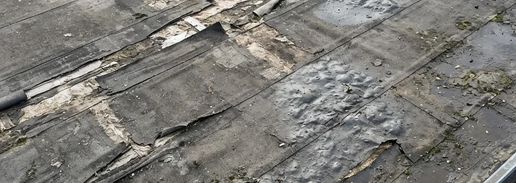 Tears in flat roof membrane