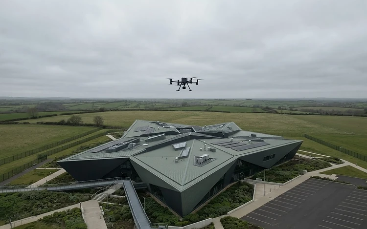Drone conducting a roof survey at altitude