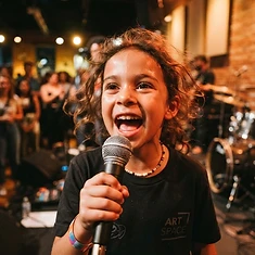 Child singing a power note with pure joy