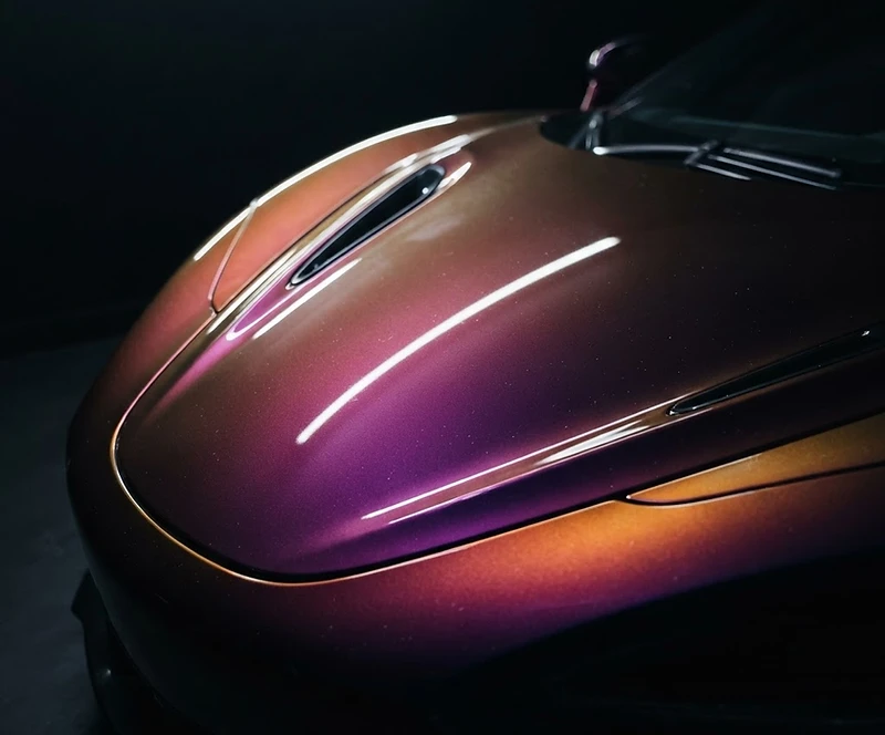 Purple-to-gold iridescent vinyl wrap on a luxury car hood