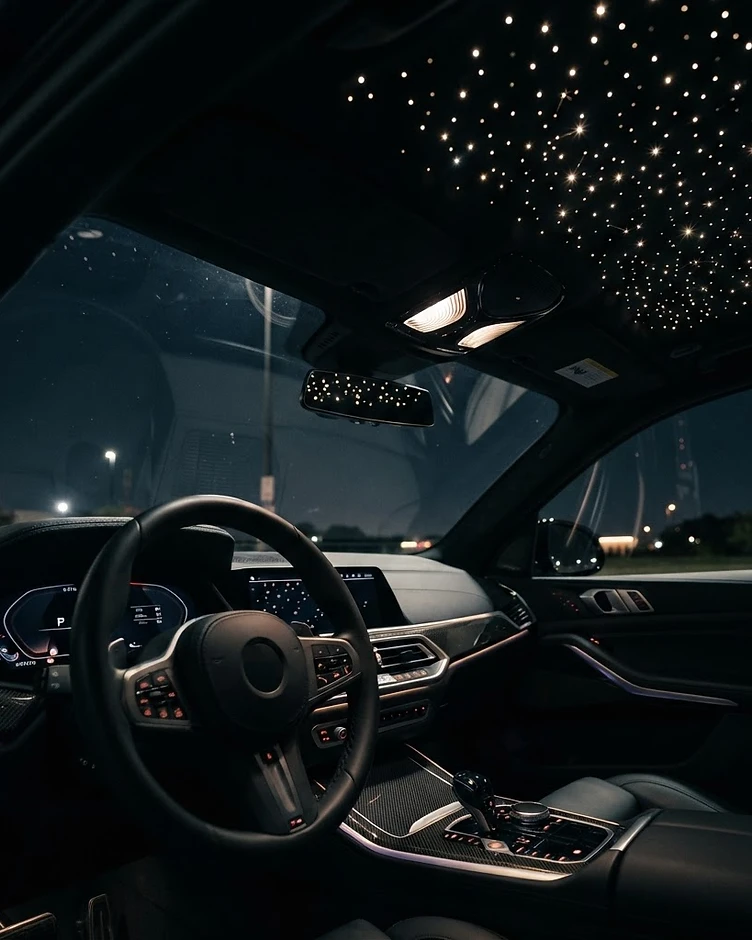 Dense starlight headliner in a dark luxury car interior