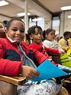 A young student smiling in an auditorium