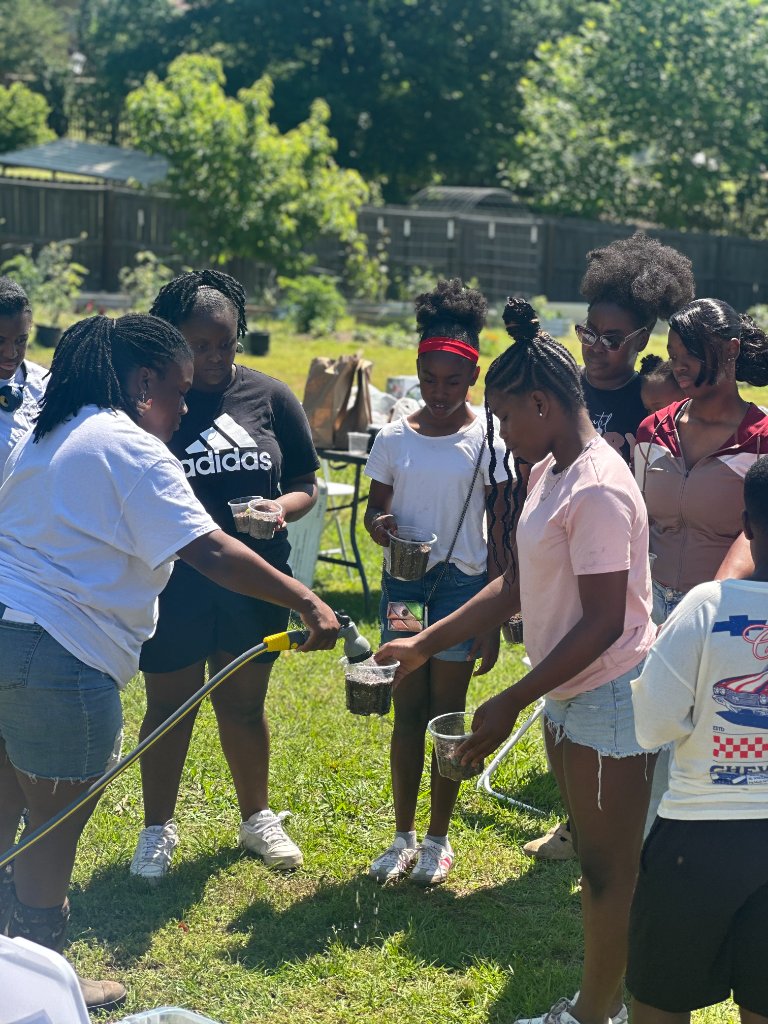 Watering Seedlings with Youth Participants