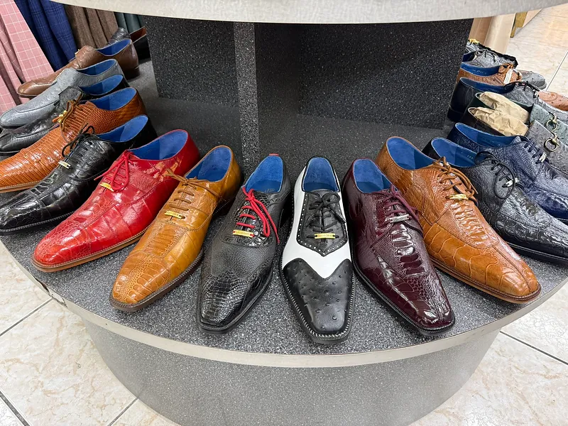 Circular display of exotic-skin Italian dress shoes in red, tan, black, and oxblood at the Paolo Cellini showroom