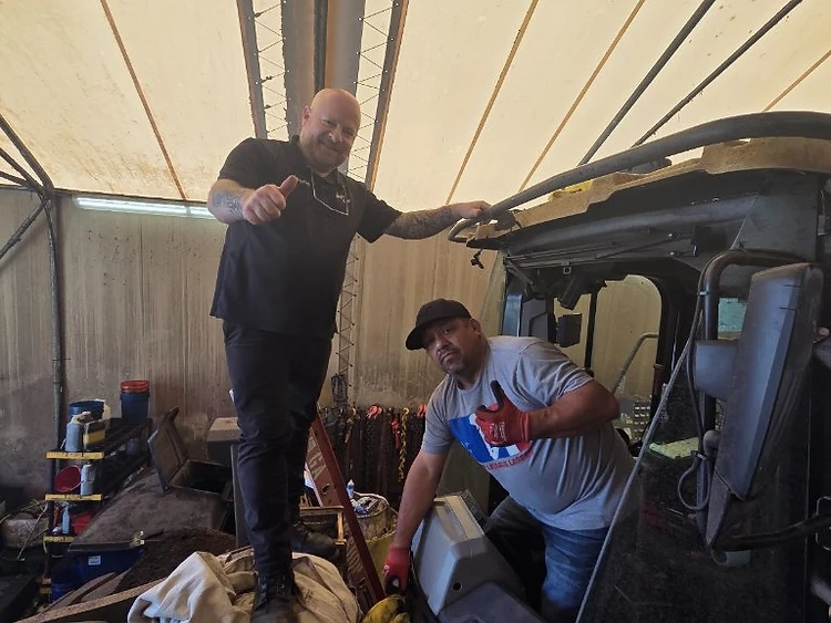 Trevor Pemberton and Jason Jones, co-owners of Auto Glass Guys, working on a vehicle cab in the shop