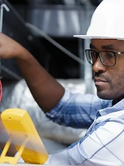Electrician testing with a multimeter