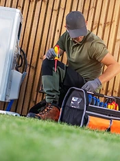 HVAC engineer servicing an outdoor unit