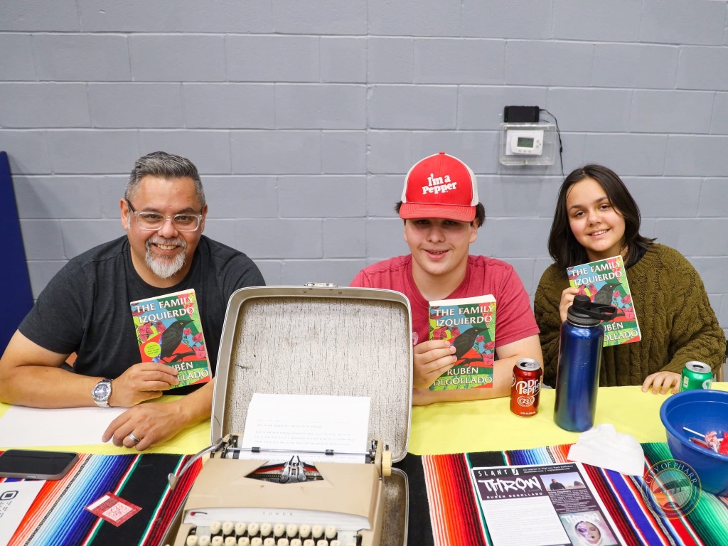 Readers gather with author Rubén Degollado to celebrate 'The Family Izquierdo' at the Lucha Libros 2025 book fair.