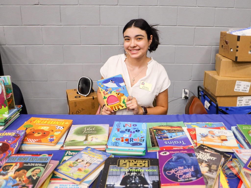 A vibrant display of bilingual children's books at the Lucha Libros 2025 vendor booth in Pharr.