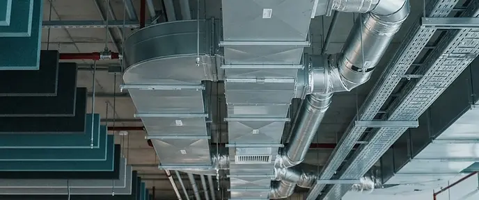 Clean galvanised air ductwork with open access panel in a commercial building