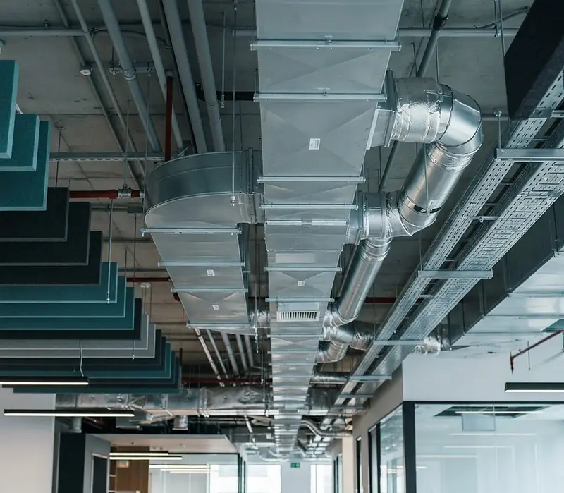 Clean galvanised air ductwork with open access panel in a commercial building