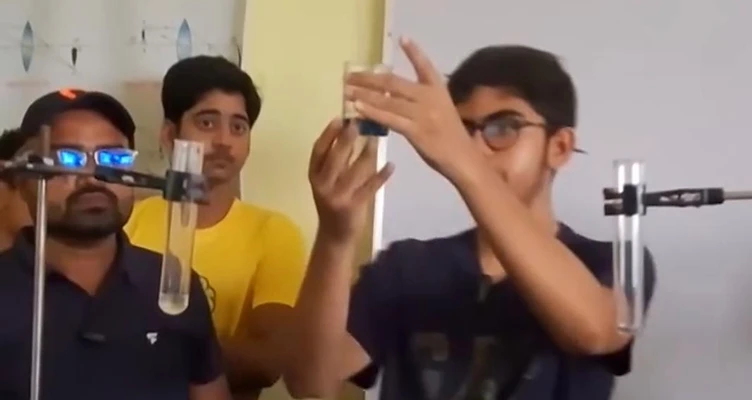 Student conducting a chemistry experiment in the Brightminds Composite Laboratory in Bihar