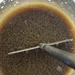 Top view of dense rare earth solids compacted in a beaker
