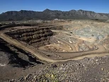 Terraced open-pit rare earth mine with spiral haul roads