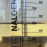 Graduated beaker showing improved settling with rare earth coagulant