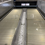 Industrial wastewater treatment facility — clarifier beds and collection channel in operation