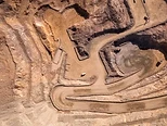 Aerial top-down view of an open-pit rare earth mine