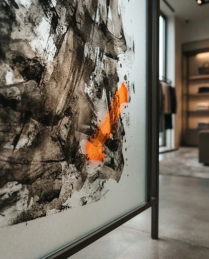 Macro close-up of art printed on a glass wall surface showing ink texture and adhesion