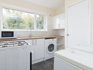 Kitchen utility room — fitted worktop, integrated appliances & window splashback