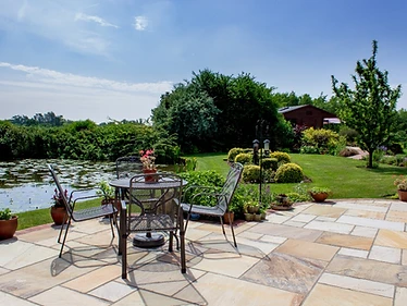 Traditional Indian sandstone installation with rustic cottage stone brick wrap around and steps in keeping with 18th century Kent property