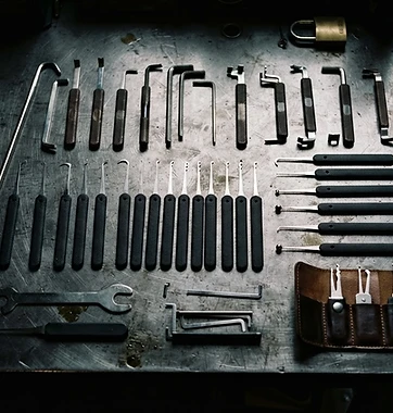 Professional locksmith tools on a steel workbench