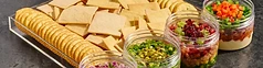 Shabbos tray of crackers with layered dip jars