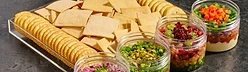 Shabbos tray of crackers with layered dip jars