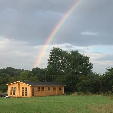 A rainbow over the cabin after rain