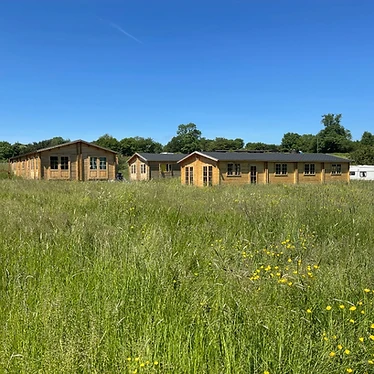 Wooden cabins in the meadow